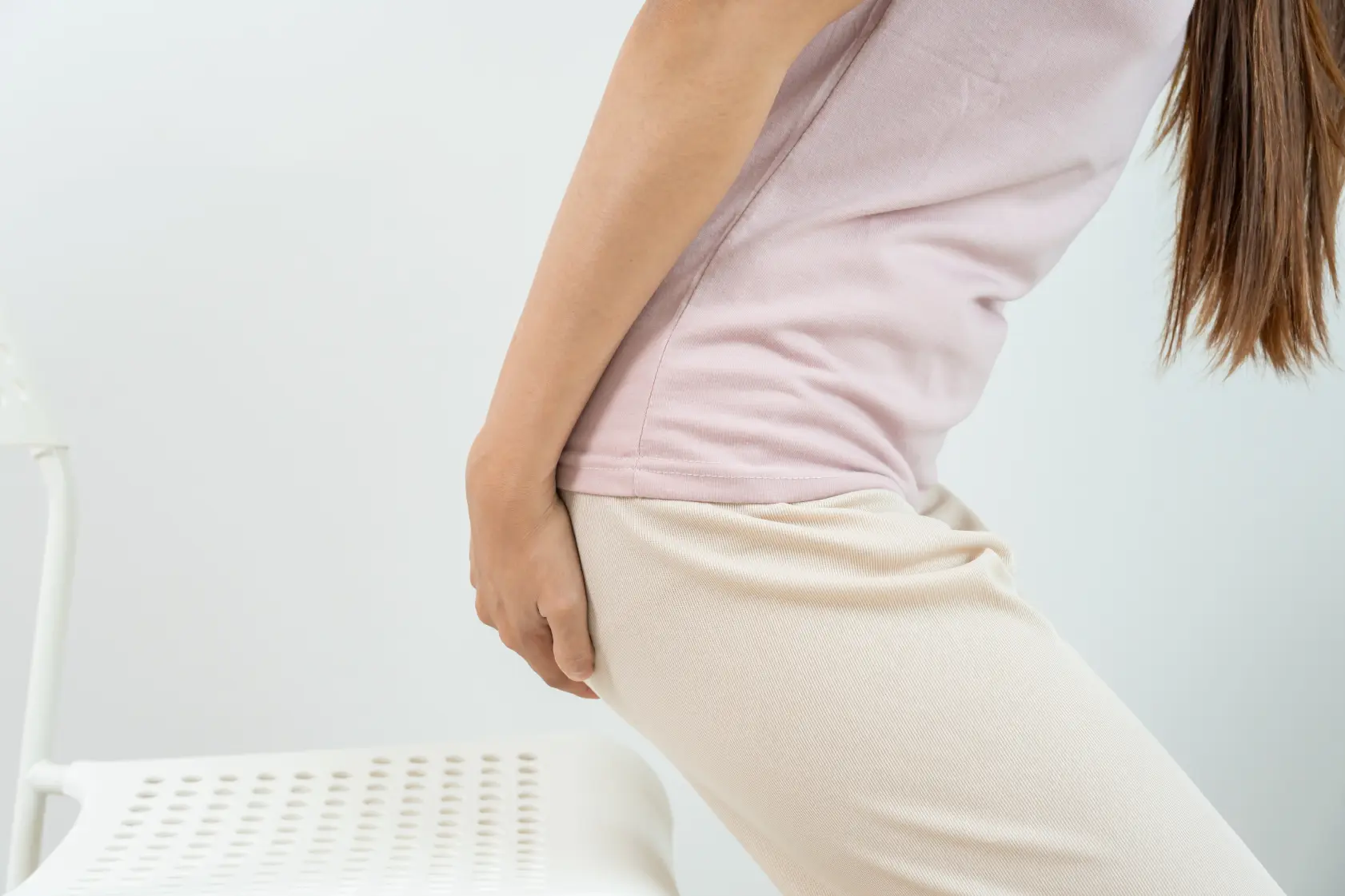 Woman experiencing pain due to anal fistula
